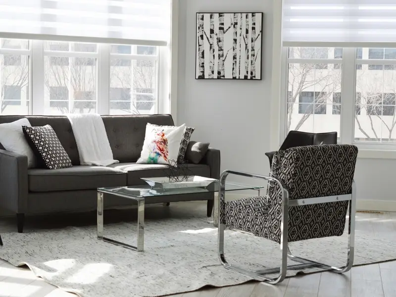 Minimalist living room with grey sofa and white walls