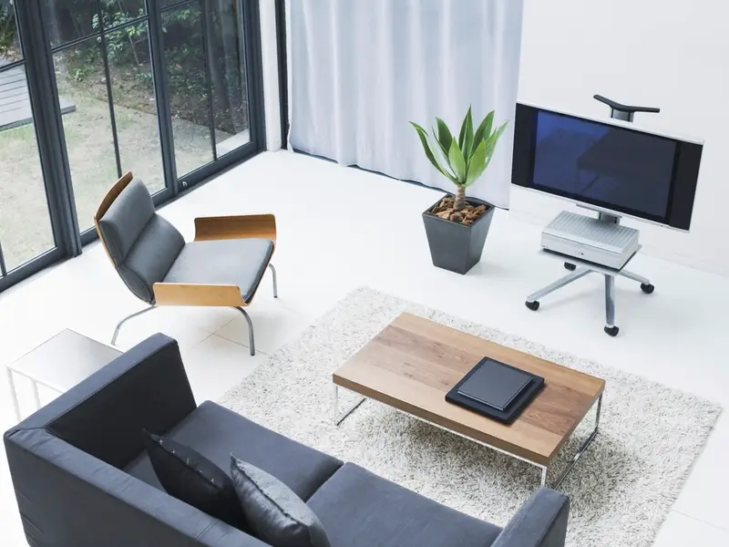 Bright modern living room with a sofa and large windows